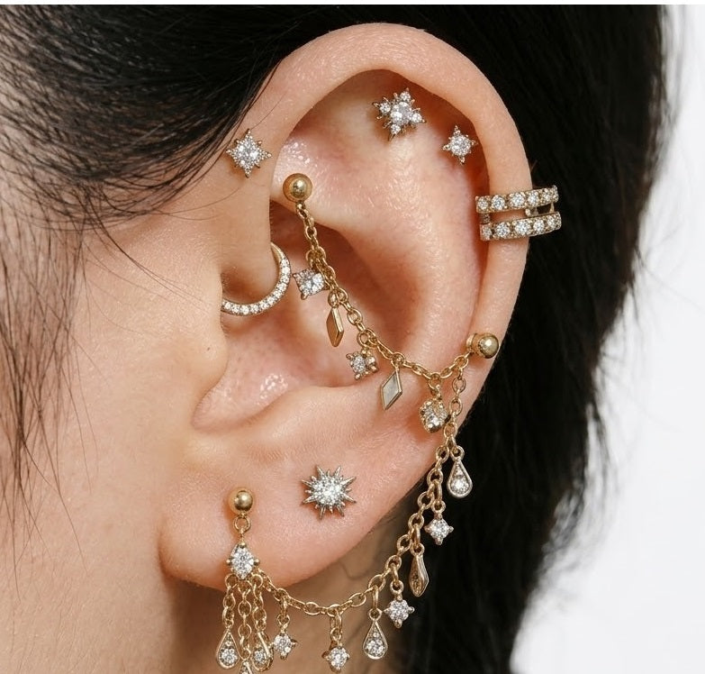 Curated ear styling with multiple gold-tone body jewelry designs